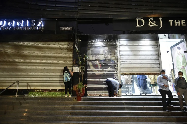 Shop owners were seen shutting their shops amid night curfew imposition