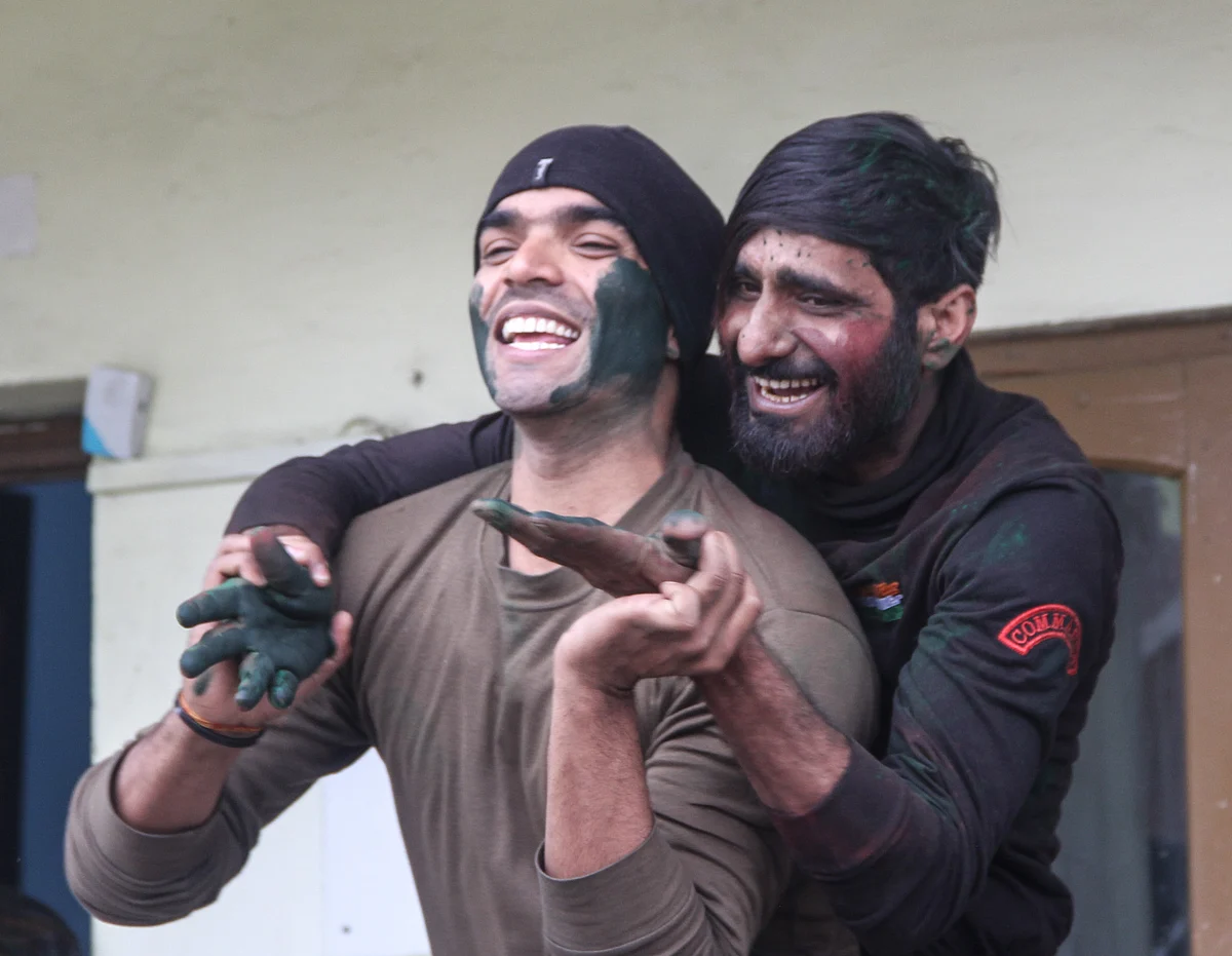 Indian Army soldiers celebrate Holi inside their base camp on the outskirts of Srinagar on March 29, 2021, in Kashmir.