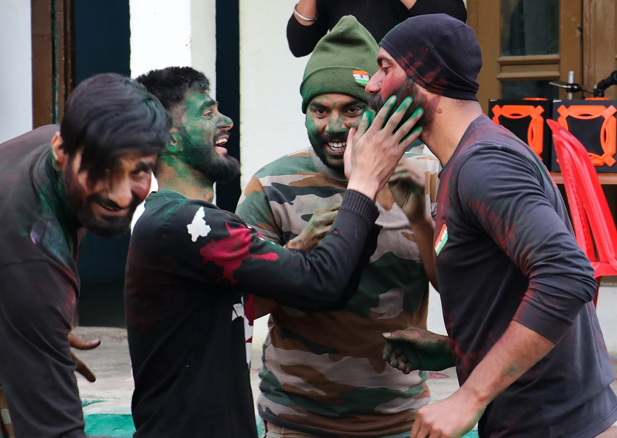 Indian Army soldiers celebrate Holi inside their base camp on the outskirts of Srinagar on March 29, 2021, in Kashmir.