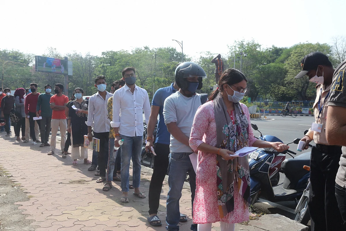 Aspirants undergo thermal screening as a precaution against Covid-19, as they arrive to appear for the MPPSC (Mains) exams, in Bhopal on Sunday