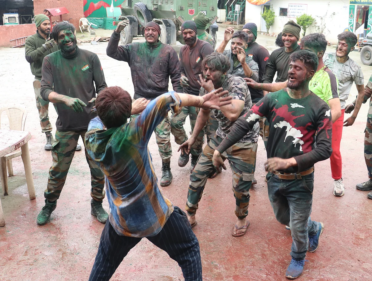 Indian army troopers, smeared in colour, dance during Holi celebrations at their camp on the outskirts of Srinagar, Kashmir.