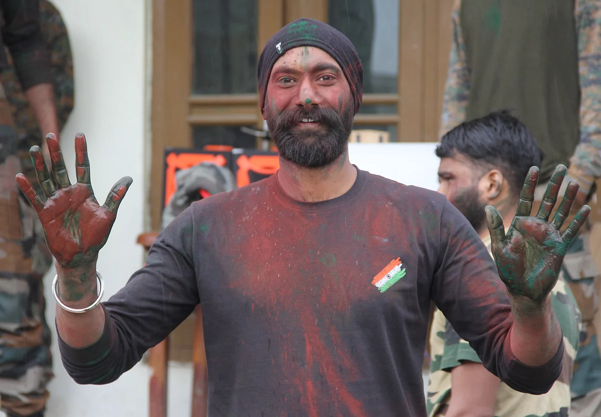 Indian Army soldiers pose for the pictures during the celebrations of the Holi festival on the outskirts of Srinagar, Kashmir.