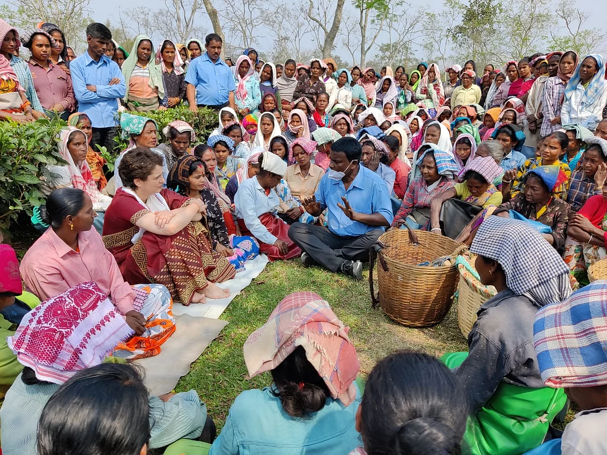 Priyanka Gandhi Vadra sitting with tea garden workers at Sadhuru tea garden, Biswanath, Assam.