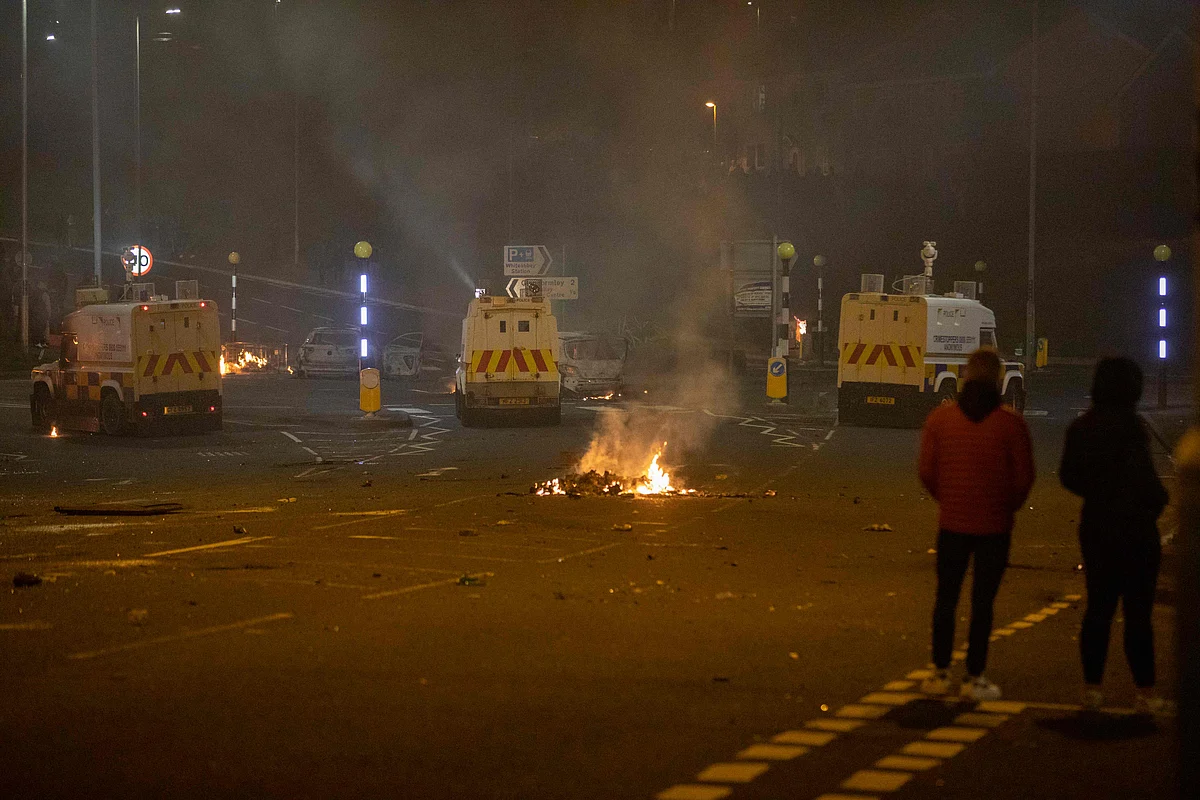 Police vehicles are positioned at the scene of violence in Newtownabbey, north of Belfast, in Northern Ireland on April 3, 2021.
