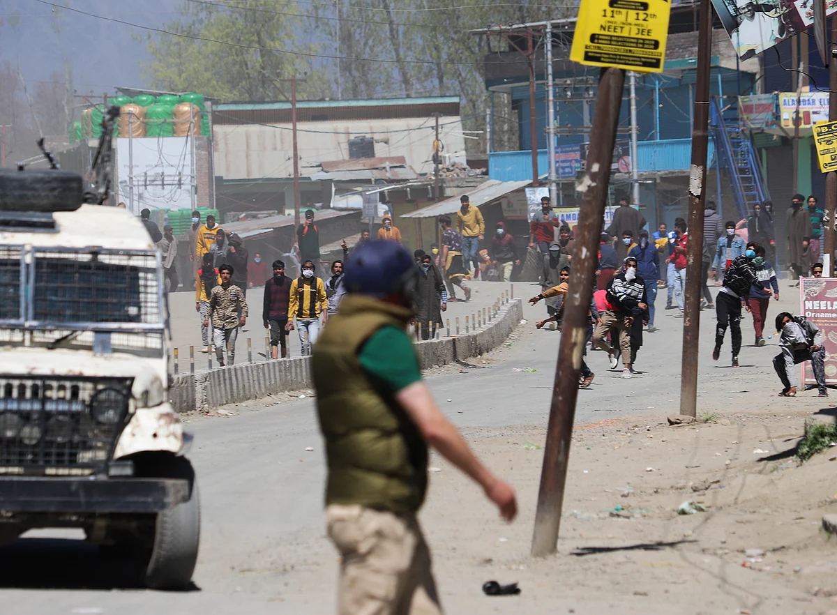 Kashmiri protesters clash with government forces near an encounter site during an encounter with militants in Pulwama district of South Kashmir.