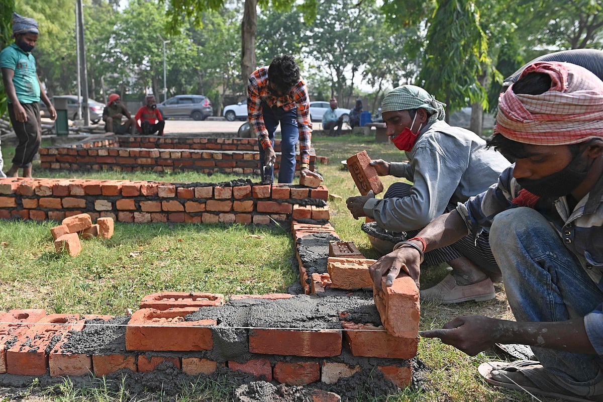 Workers are seen constructing makeshift platforms for funeral pyres inside the premises of a crematorium in New Delhi on April 27, 2021