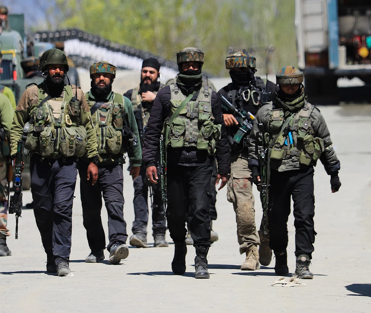 Army soldiers leave after an encounter with militants in the Pulwama district of South Kashmir. Three militants were killed in the encounter.
