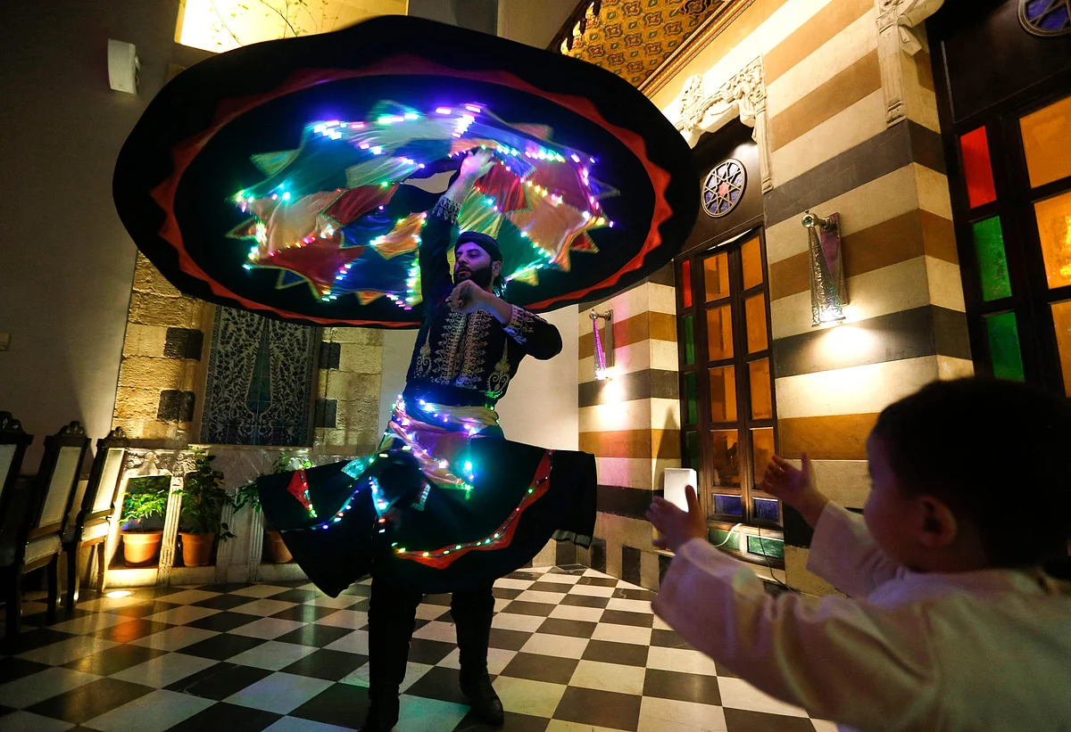 Sufi Dervish dancer Muayad al-Kharrat, 28, dances with his lit dress at a restaurant in the Shahgur district of the old city of Syrias capital Damascus on May 5, 2021.