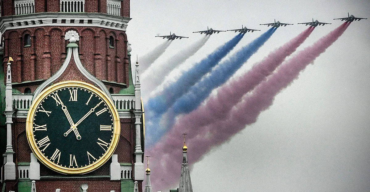 Russian Sukhoi Su-25 assault aircrafts release smoke in the colours of the Russian flag while flying over central Moscow during the Victory Day military parade on May 9, 2021.