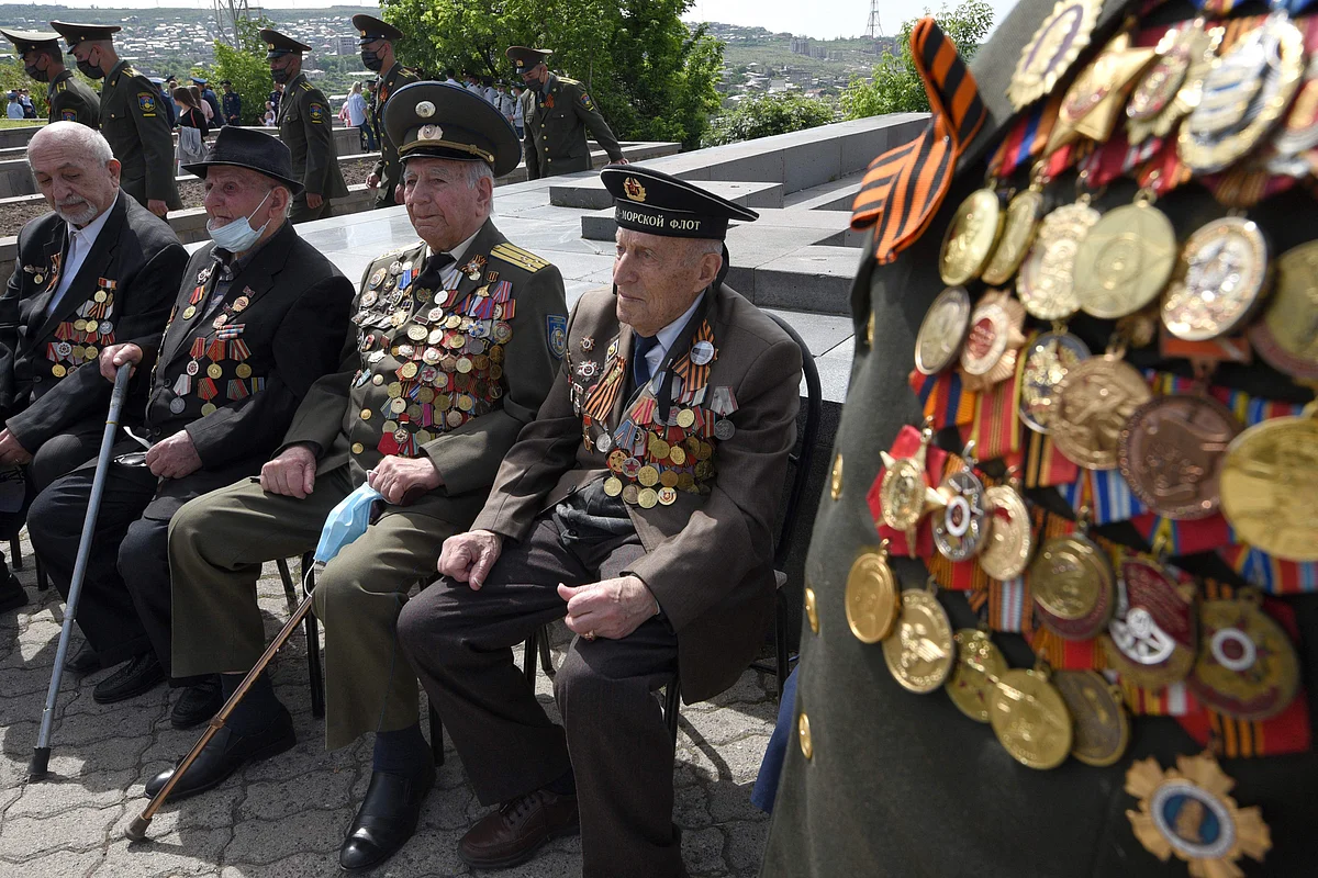 Veterans, including World War Two veteran Nerses Simonyan (R), 97, attend a ceremony at the Mother Armenia monument in the Victory Park during the Victory Day celebrations in Yerevan on May 9, 2021.