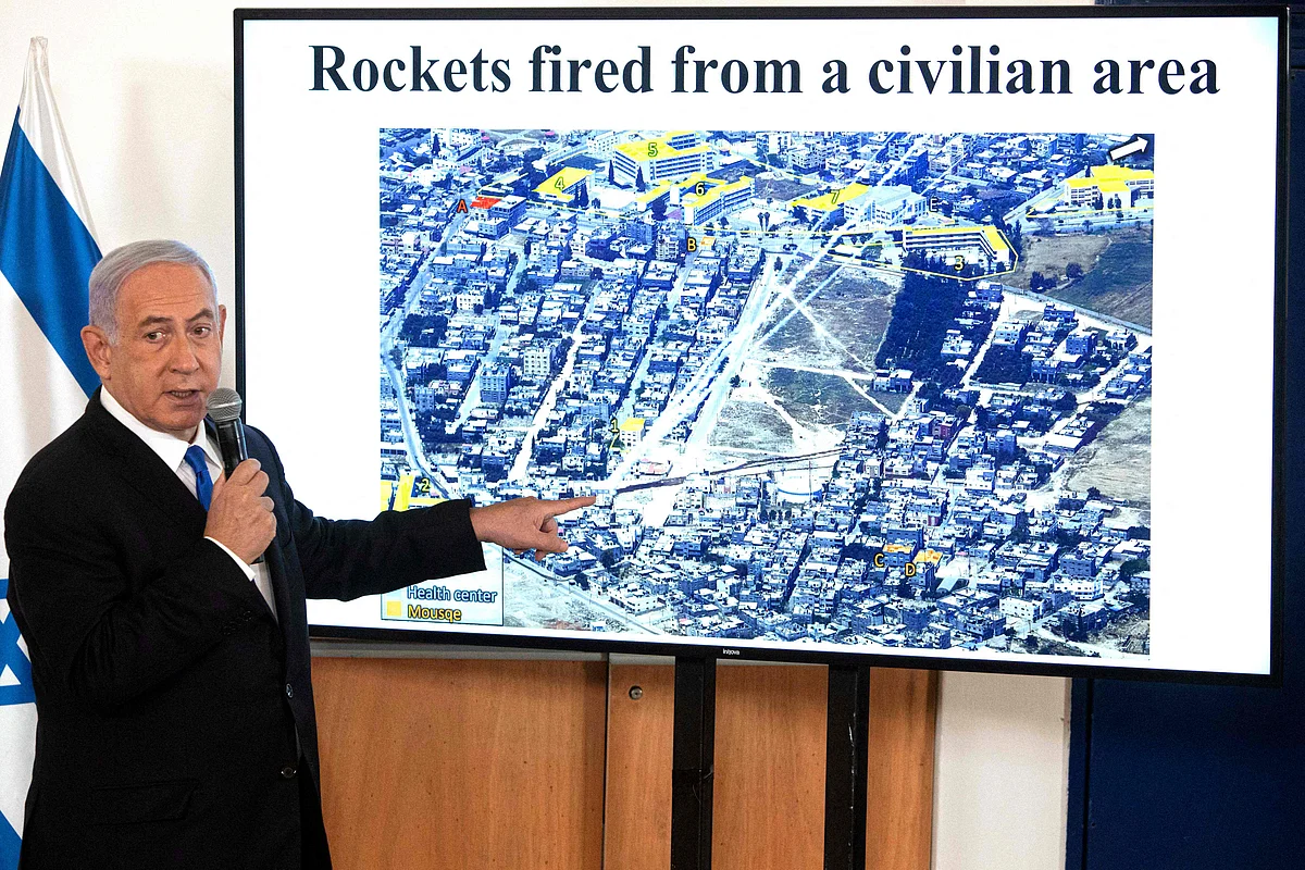 Israeli PM Benjamin Netanyahu gestures as he shows a slideshow during a briefing to ambassadors to Israel at the Hakirya military base in Tel Aviv, Israel on Wednesday. Israel is studying whether conditions are right to stop bombing Palestinian militants in Gaza but is preparing for "more days" of strikes if necessary, an Israeli military source said.