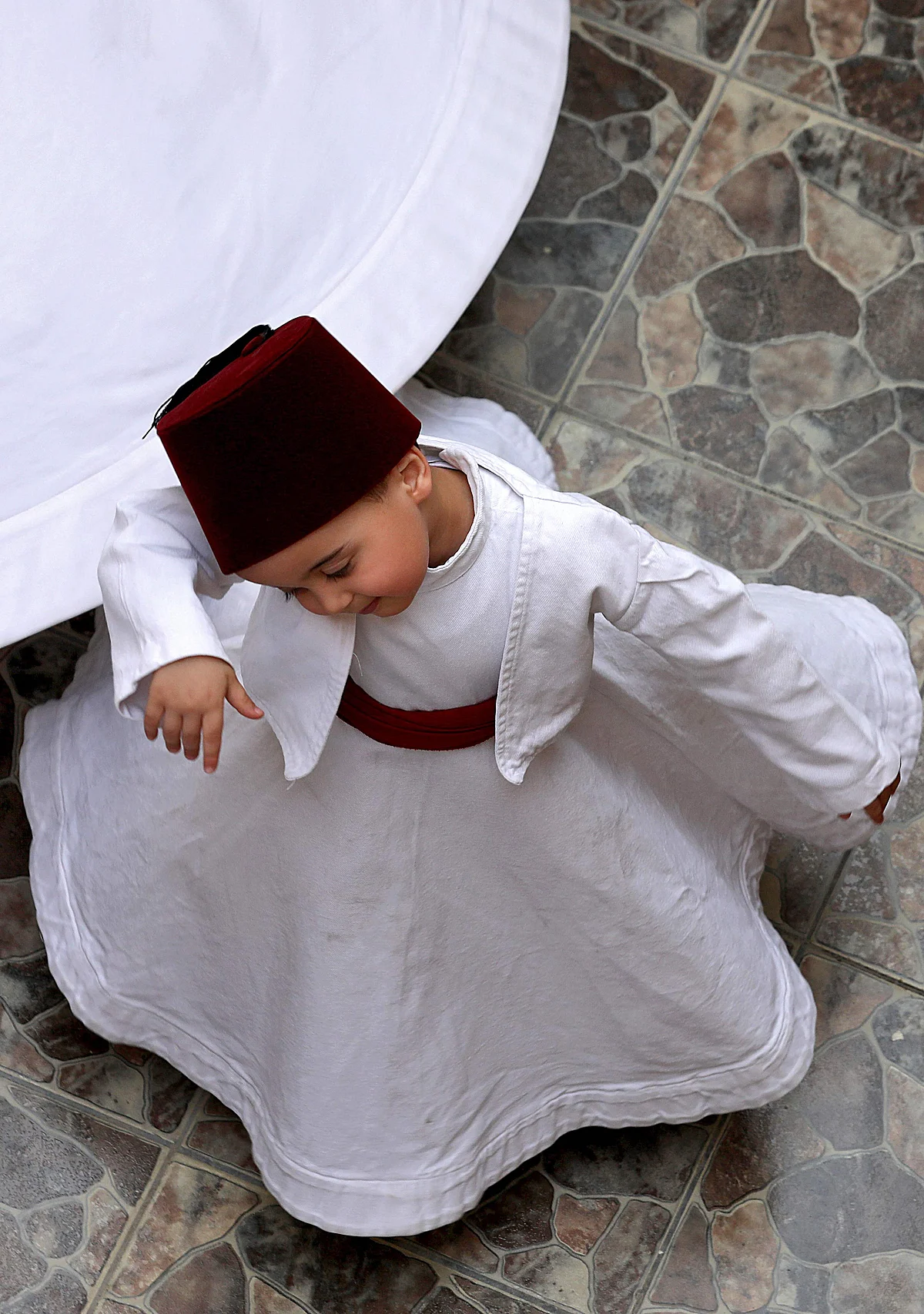 Three-year-old Sufi Dervish dancer Anas al-Kharrat dances at his home in the Shahgur district of the old city of Syrias capital Damascus on May 6, 2021.