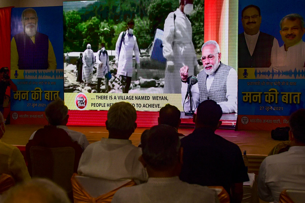 BJP workers listen to PM Modis Mann ki Baat in New Delhi, Sunday, June 27, 2021.