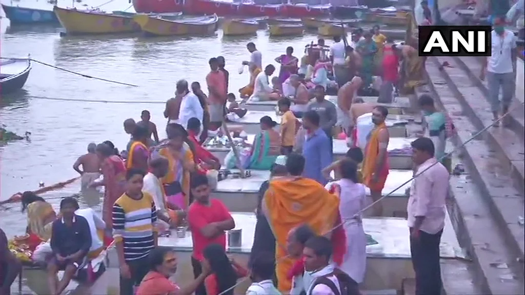 Devotees offer prayers at Ganga Ghat on the occasion of the Ganga Dussehra festival in the ongoing Covid-induced lockdown, in Varanasi, Sunday, June 20, 2021.