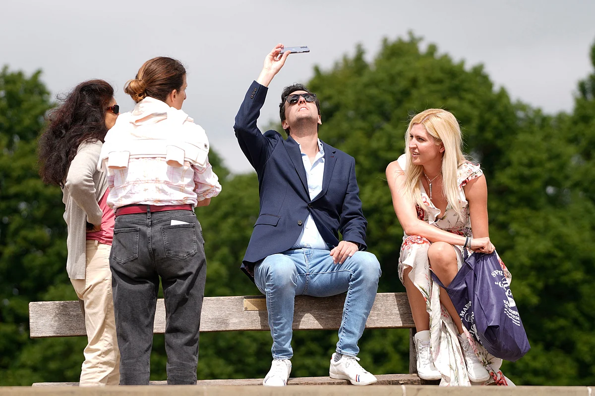 Members of the public watch a partial solar eclipse from Primrose Hill in central London on June 10, 2021.