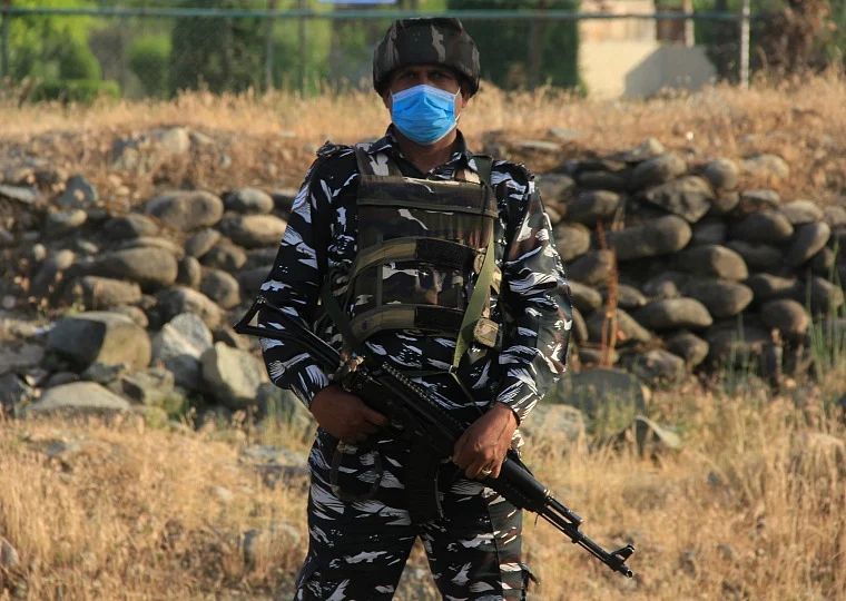 CRPF personnel stands guard on a road in outskirts of Srinagar