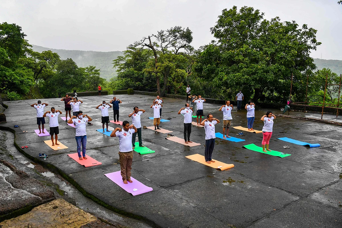 People take part in a yoga session at the Kanheri Caves on the outskirts of Mumbai on June 21, 2021, to mark International Yoga Day.