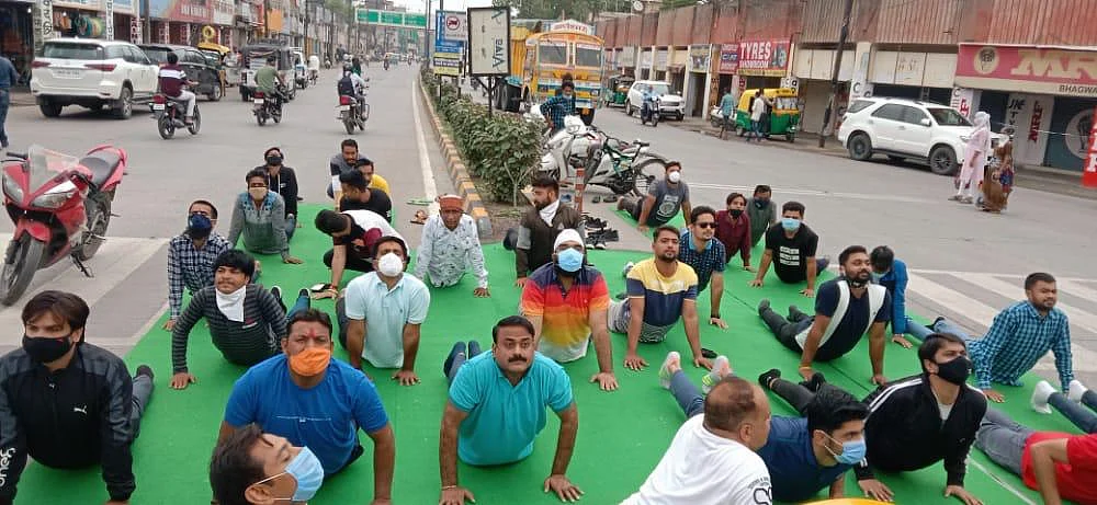BJYM members performing yoga before the statue of Swami Vivekanand in Indore on Monday