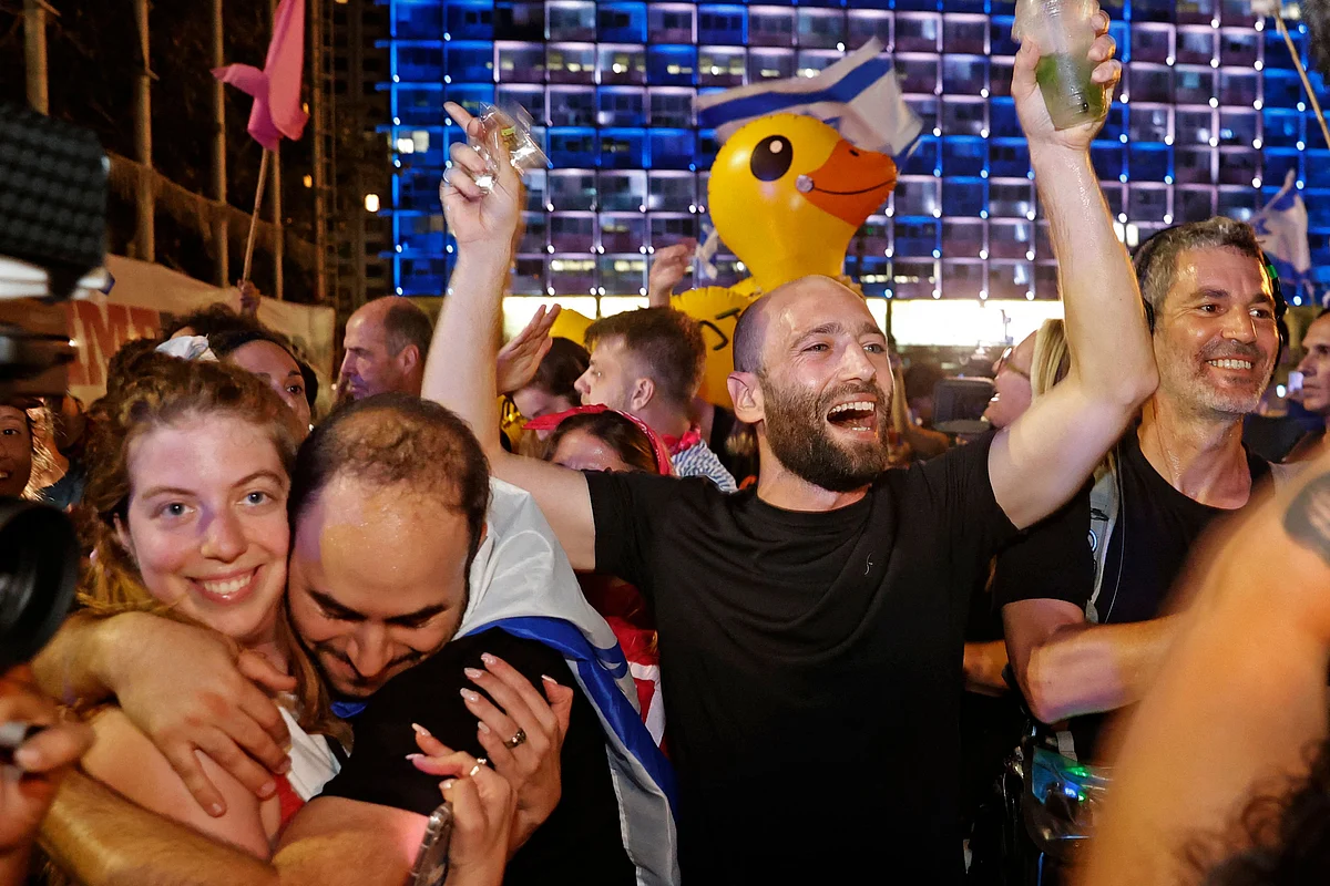 Israeli demonstrators celebrate the passing of a Knesset vote confirming a new coalition government during a rally in Rabin Square in the Mediterranean coastal city of Tel Aviv on June 13, 2021.