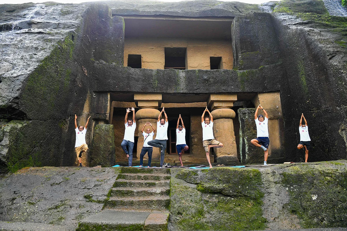 People take part in a yoga session at the Kanheri Caves on the outskirts of Mumbai on June 21, 2021, to mark International Yoga Day.