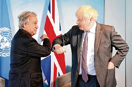 UK PM Boris Johnson (R) greets UN Secretary-General Antonio Guterres in Cornwall.