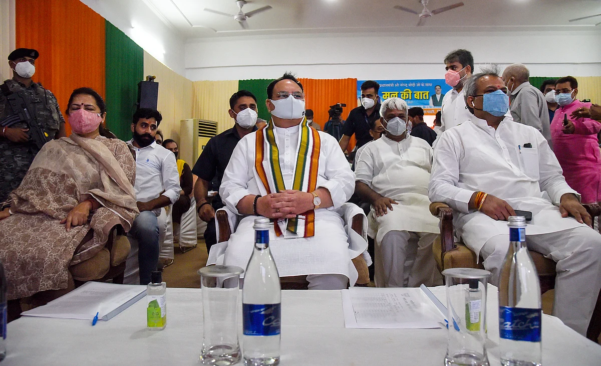 BJP National President JP Nadda, party President Adesh Gupta and party leader Meenakshi Lekhi listen to Prime Minister Narendra Modis Mann ki Baat, in New Delhi on Sunday.