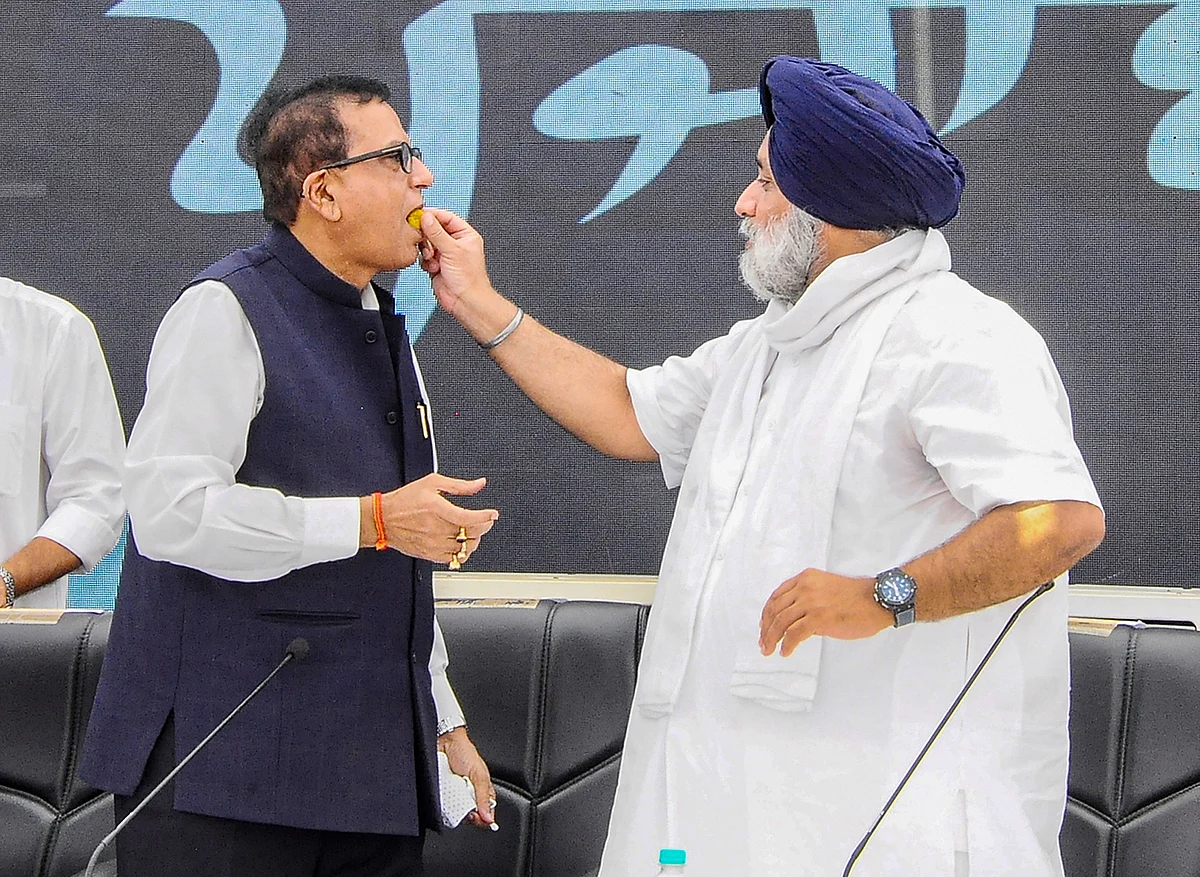 Chandigarh: Shiromani Akali Dal (SAD) President Sukhbir Singh Badal offers sweets to Bahujan?Samaj Party (BSP) Secretary General Satish Chandra Mishra during a joint press conference at the SAD head office in Chandigarh, Saturday, June 12, 2021. The Shiromani Akali Dal (SAD) and the Bahujan Samaj Party (BSP) formed an alliance on Saturday for the 2022 Punjab Assembly election.