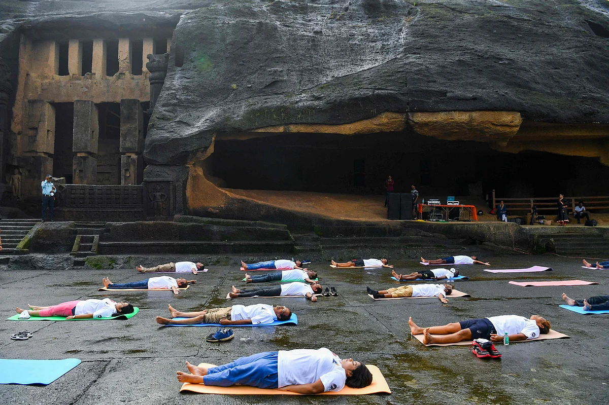 People take part in a yoga session at the Kanheri Caves on the outskirts of Mumbai on June 21, 2021, to mark International Yoga Day.
