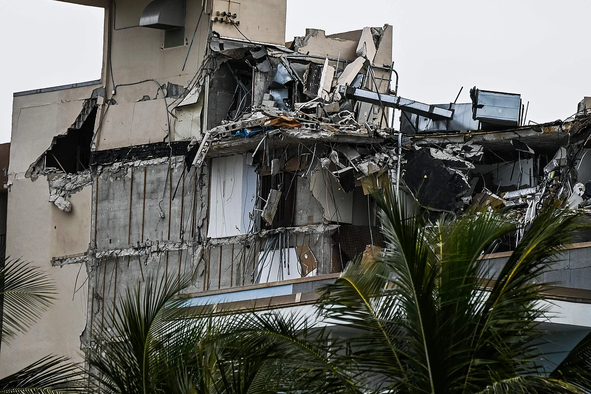 Rubble hangs from a partially collapsed building in Surfside, Florida, north of Miami Beach, on June 26, 2021