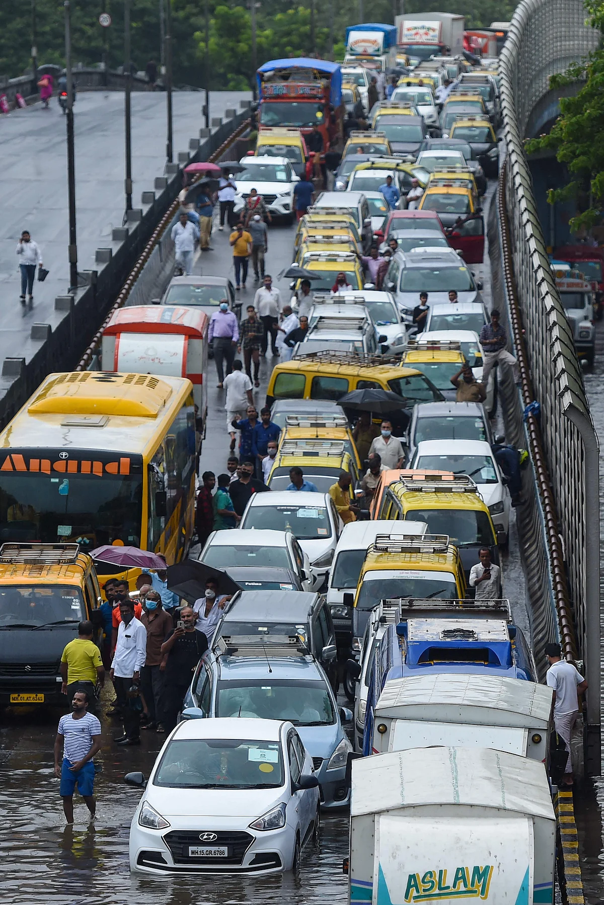 Traffic stands at a stand still on a flooded road following heavy monsoon rains in Mumbai on June 9, 2021.
