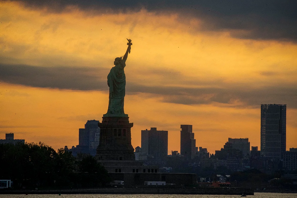 The Statue of Liberty is seen while the Moon partially covers the sun during a partial solar eclipse on June 10, 2021 seen from Jersey City, New Jersey.