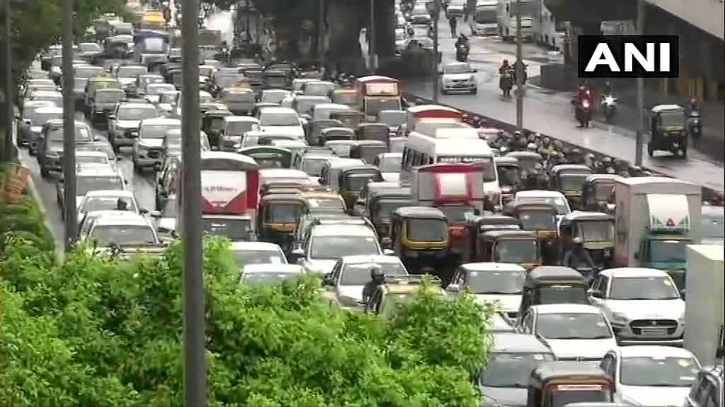 Heavy rainfall in Mumbai causes traffic snarls in different parts of the city on Wednesday. Visuals from Western Express Highway.