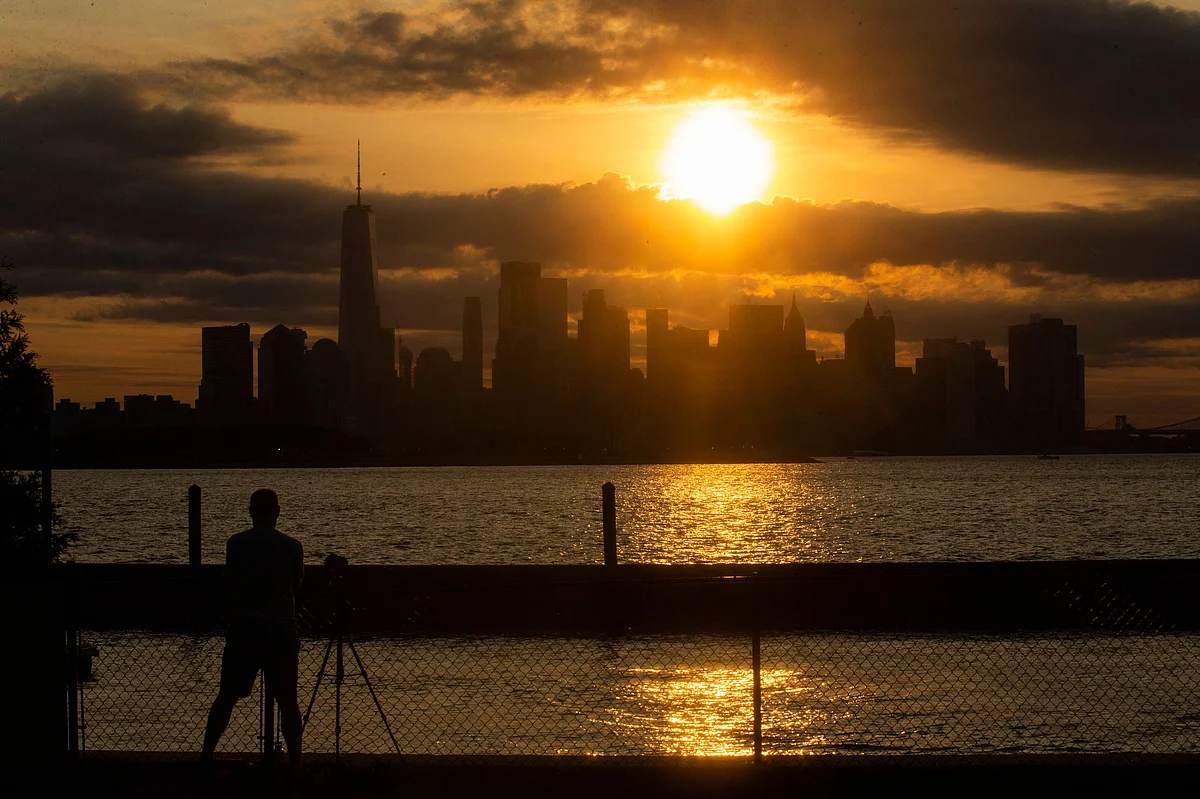 The New York skyline is seen as the Moon partially covers the sun during a partial solar eclipse on June 10, 2021 seen from Jersey City, New Jersey.