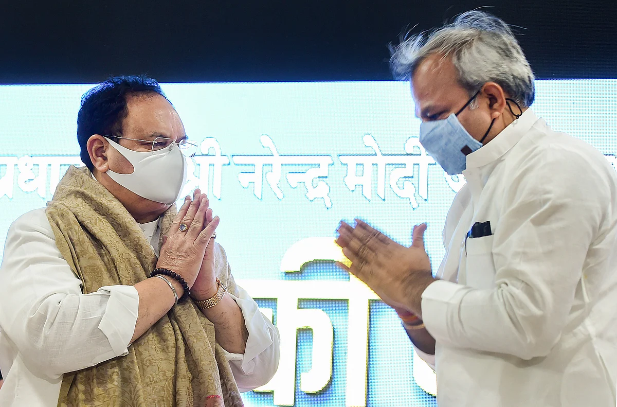 BJP National President JP Nadda (L) gestures to partys Delhi President Adesh Gupta (R) during PM Modis Mann ki Baat in New Delhi, Sunday, June 27, 2021.