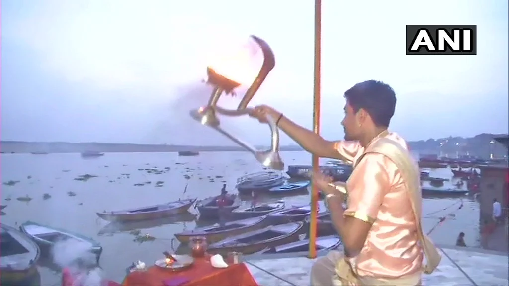 A pandit offers prayers at Ganga Ghat on the occasion of the Ganga Dussehra festival in the ongoing Covid-induced lockdown, in Varanasi, Sunday, June 20, 2021.