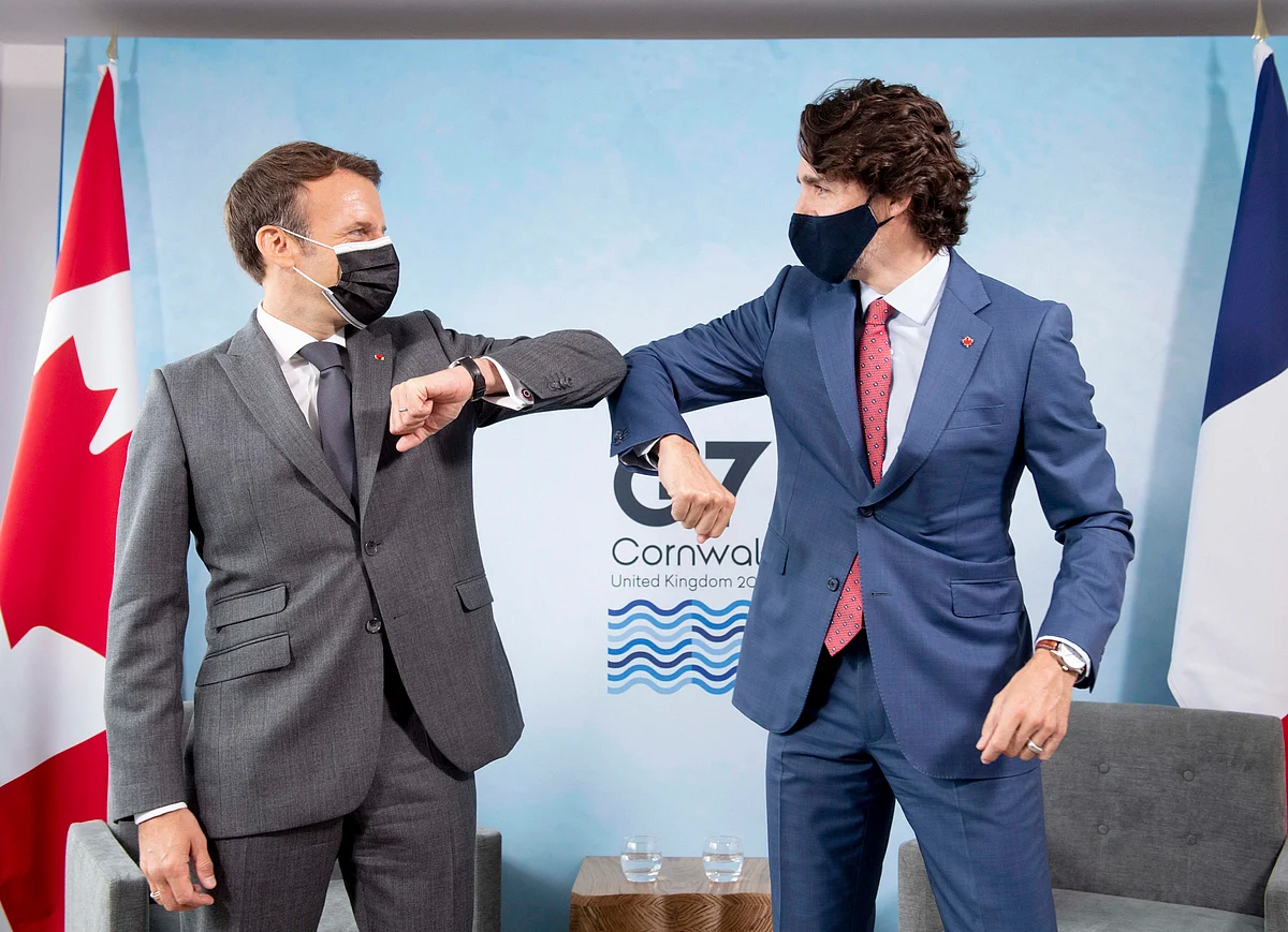 Canadian Prime Minister Justin Trudeau, right, welcomes French President Emmanuel Macron as the two leaders meet at the G7 Summit in Carbis Bay, Cornwall, England, Saturday, June 12, 2021.