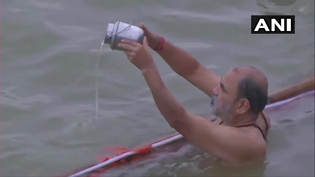 A devotee offer prayers at Ganga Ghat on the occasion of the Ganga Dussehra festival in the ongoing Covid-induced lockdown, in Varanasi, Sunday, June 20, 2021.