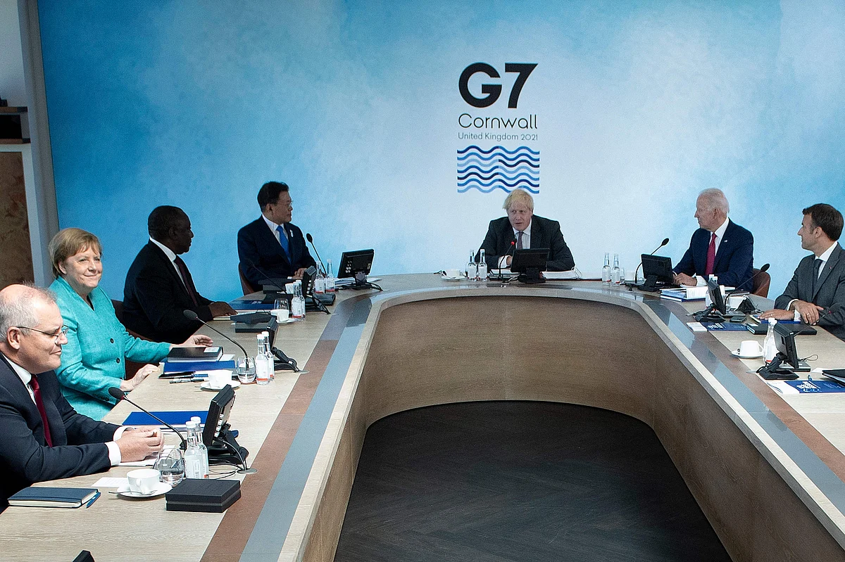(L-R) Australias Prime Minister Scott Morrison, Germanys Chancellor Angela Merkel, South Africas President Cyril Ramaphosa, South Koreas President Moon Jae-in, Britains Prime Minister Boris Johnson, US President Joe Biden and Frances President Emmanuel Macron wait for the start of a working session at the G7 summit in Carbis Bay, Cornwall on June 12, 2021.