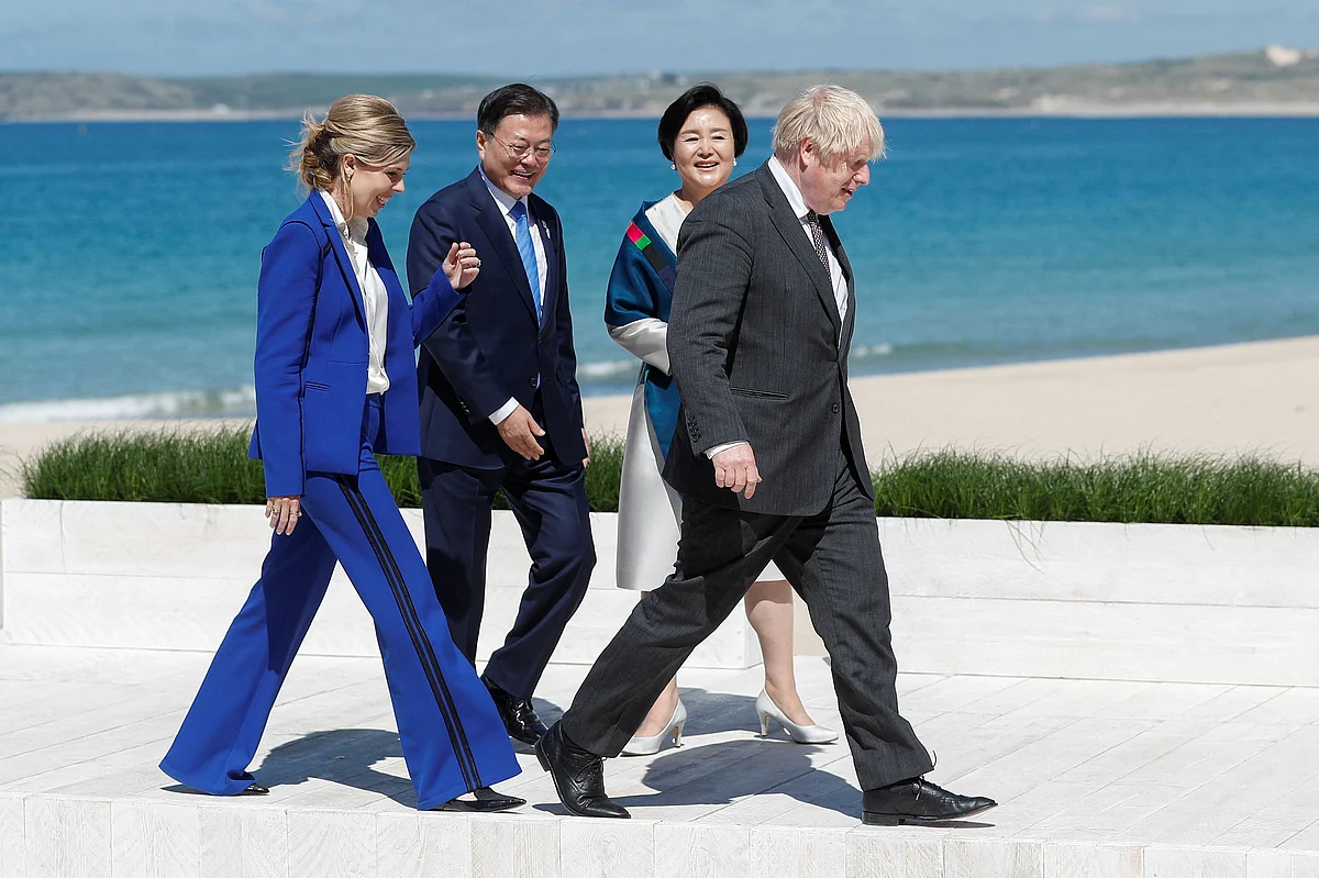 Britains Prime Minister Boris Johnson (R) and his wife Carrie Johnson (L) greet South Koreas President Moon Jae-in (2nd L) and his wife Kim Jung-sook (2nd R) during an official welcome during the G7 summit in Carbis Bay, Cornwall on June 12, 2021.