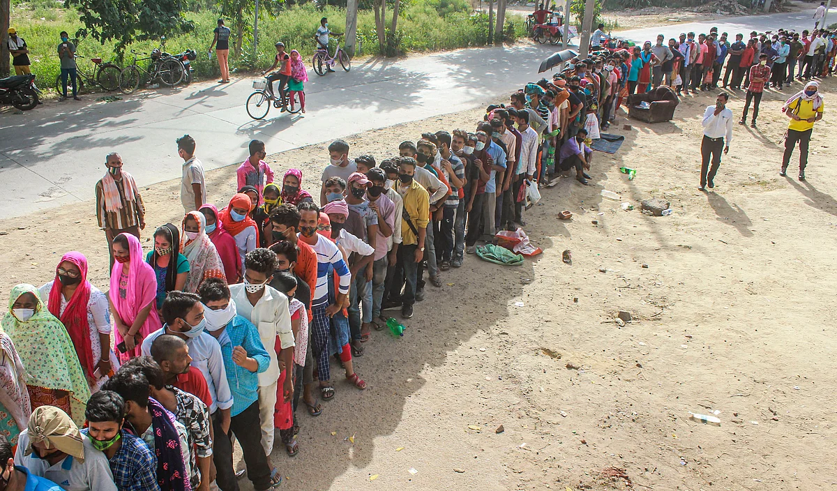 Beneficiaries not adhering to social distancing norms, wait in queues to receive COVID-19 vaccine dose, at a government school at Fazilpur village in Gurugram, Wednesday, June 30, 2021.