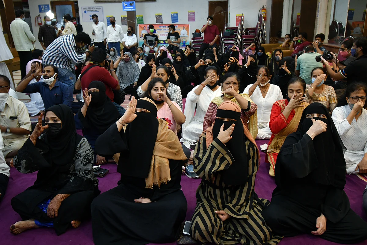 People perform yoga on the occasion of 7th International Yoga Day, in Mumbai on Monday.
