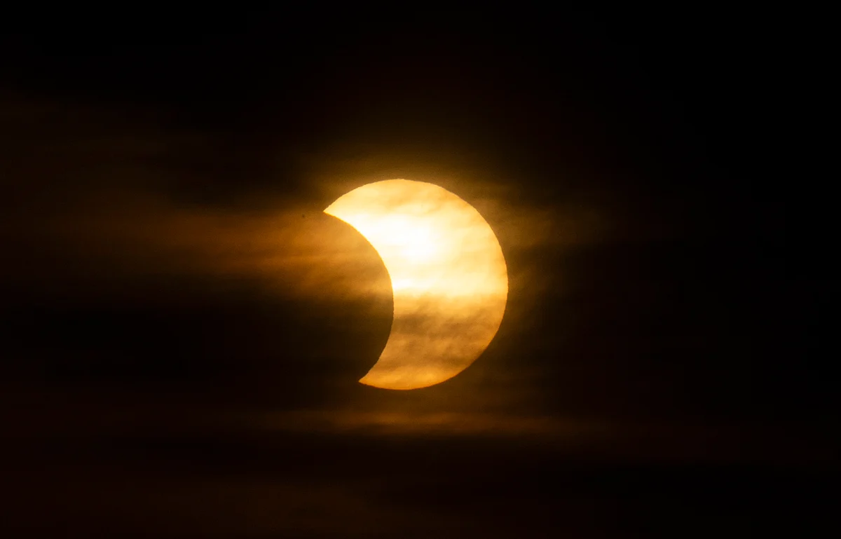 A eclipsed sun rises over New York City on June 10, 2021 seen from Jersey City, New Jersey.