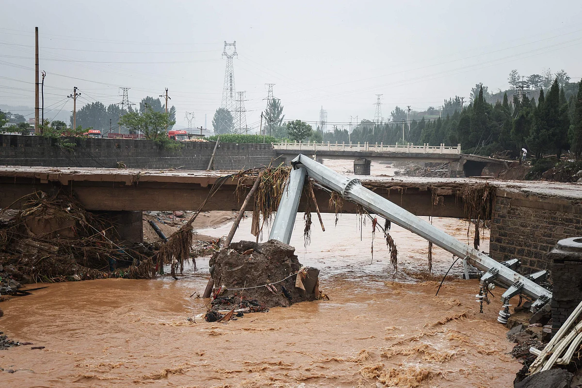 This photo taken on July 21, 2021 shows a utility pole bent in half following heavy rains which caused severe flooding in Gongyi in Chinas central Henan province.
