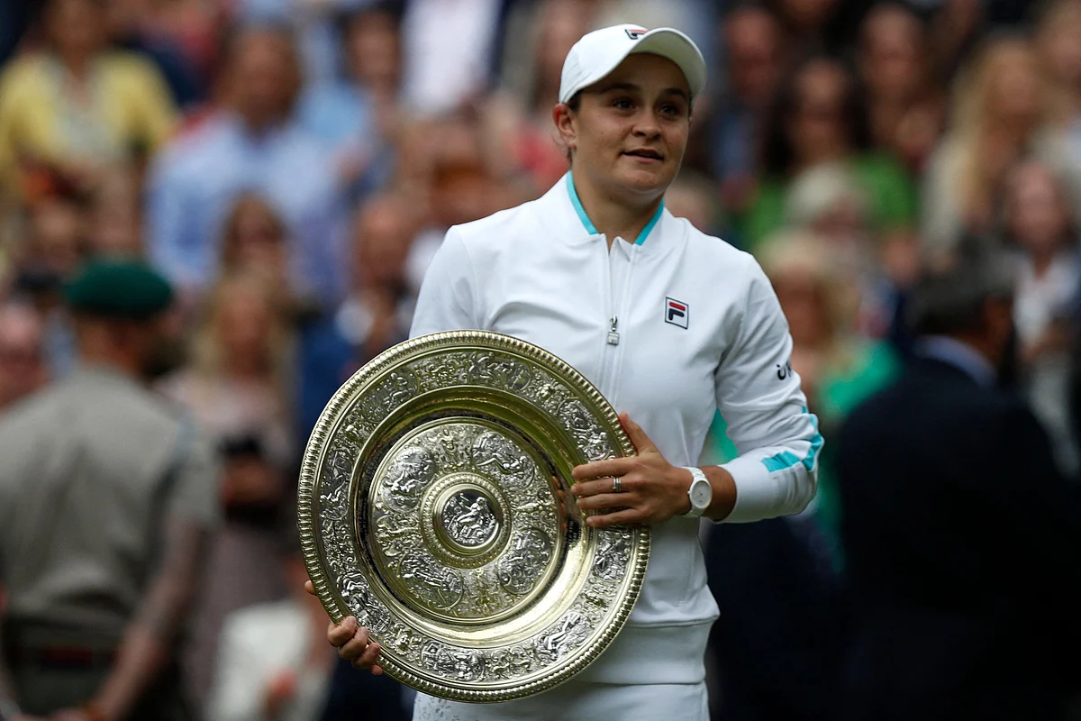 Australias Ashleigh Barty holds the trophy after defeating Czech Republics Karolina Pliskova during their womens singles final match on the twelfth day of the 2021 Wimbledon Championships at The All England Tennis Club in Wimbledon, southwest London, on July 10, 2021.