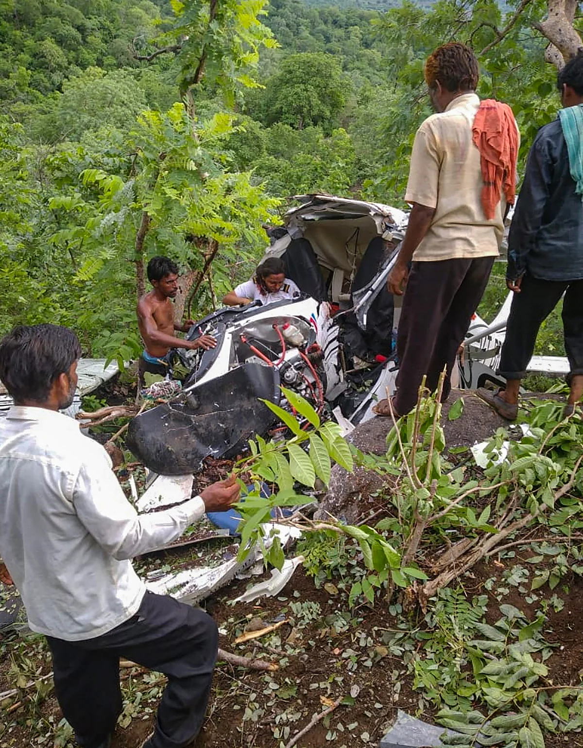 Jalgaon: Locals gather near the site after a helicopter crashed in Jalgaon district, Friday, July 16, 2021. A pilot died and another was injured in the accident.