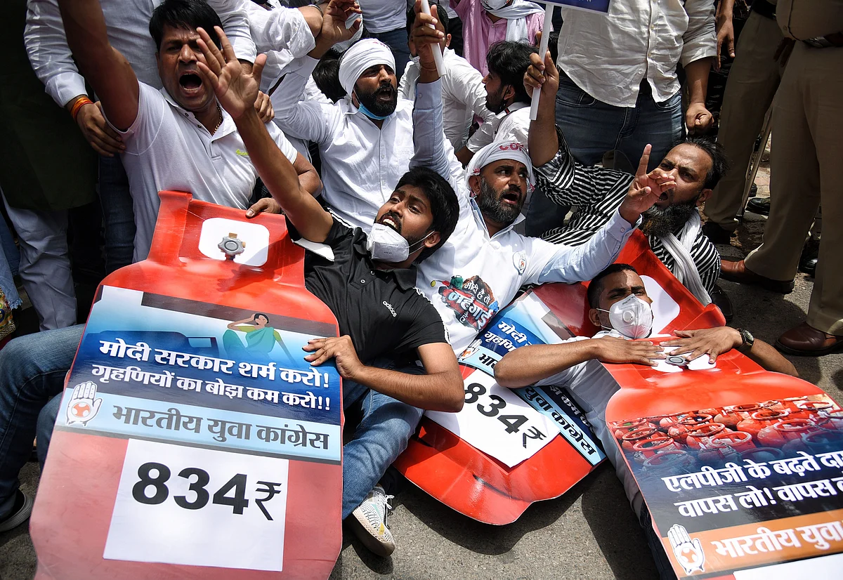 Indian Youth Congress (IYC) supporters stage a protest against the hike in fuel prices outside Shastri Bhawan, in New Delhi on Saturday.
