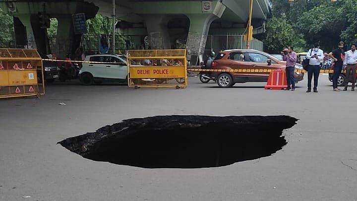 In Pictures: Massive chunk of road caves in near Delhi's IIT traffic light; netizens aghast