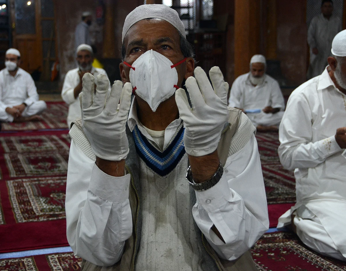 A man offers Eid-ul-Adha prayers wearing mask and gloves as a precautionary measure against COVID-19 at Aali Masjid in Srinagar,
Jammu & Kashmir on 21 July, 2021.