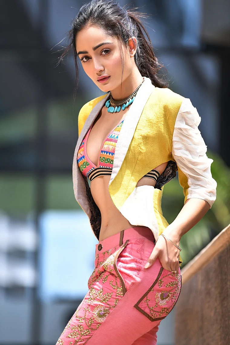 Linen and chanderi panelled jacket teamed with a hand embroidered bikini top and crosstitch worked capri pants