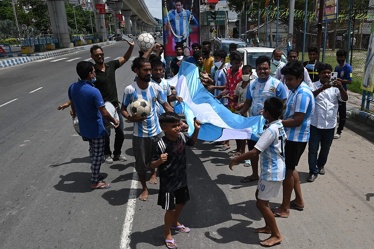 Argentina football fans celebrate along a road after winning the Conmebol 2021 Copa America football tournament final match against Brazil, in Kolkata on July 11, 2021.